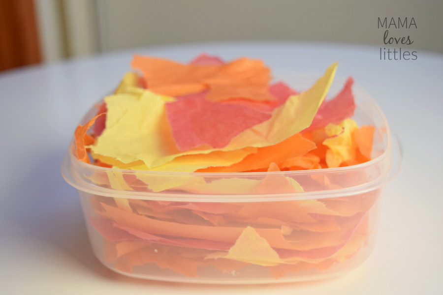 Red, orange and yellow tissue paper pieces in container