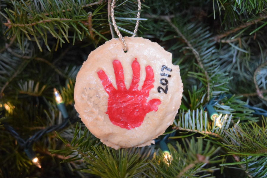 homemade salt dough Christmas ornament with child's handprint painted in red 