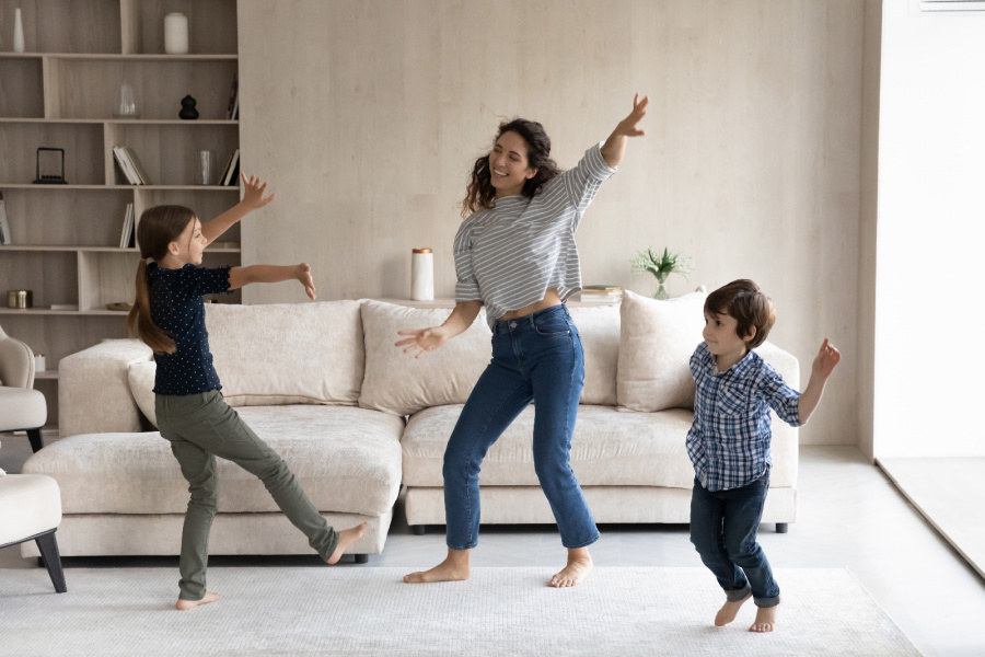 Mom finding time to exercise by dancing with her kids in the living room