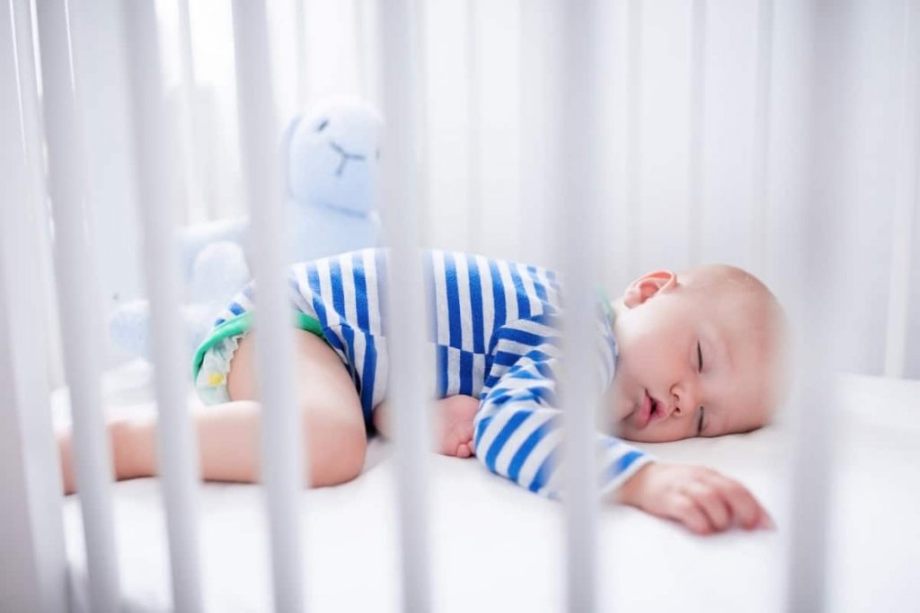 baby asleep in crib on stomach